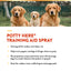 Three dogs sitting together with promotional text for Potty Here Training Aid Spray.